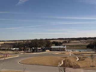 Scenic view of a community park with winding roads and open fields in Lariat by Landsea Homes (Liberty Hill, TX).