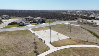 Aerial view of Steele Creek by D.R. Horton in Cibolo, TX, showcasing a basketball court and serene residential surroundings.