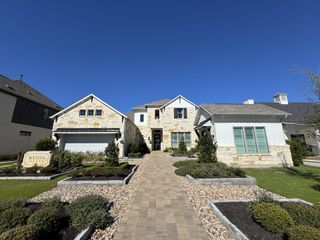 A beautiful stone and siding home with manicured landscaping in Santa Rita Ranch by Westin Homes (Liberty Hill, TX).