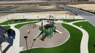 Community Amenities A vibrant playground with slides and swings in Cielo Gardens: Welton Collection by Lennar, Jarrell, TX.