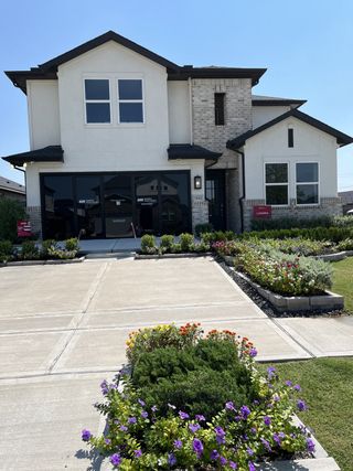 A modern two-story home with a landscaped yard in Bridge Creek 45s and 50s by Taylor Morrison (Cypress, TX).