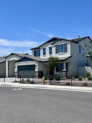 A modern two-story home with a fenced yard in Laveen Vistas II by Homes by Towne (Phoenix, AZ).