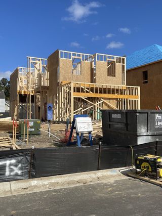 Street view New construction in progress at Park's Edge at Carolina Bay by Pulte Homes, Charleston, SC, featuring framed structures.