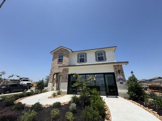 A modern brick and siding home with manicured landscaping in Hacienda by D.R. Horton (San Antonio, TX).