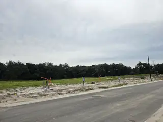 Street view A developing lot with a scenic backdrop in Hammock Oaks Villas by Ryan Homes, Lady Lake, FL.