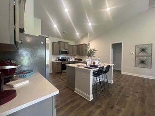 A modern kitchen with sleek appliances, a central island, and stylish lighting, offering an inviting space for culinary creativity.