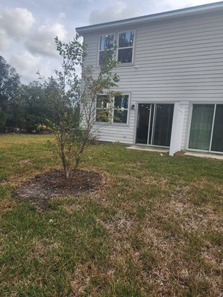 A modern home with clean lines and a lush backyard in The Villas at Bishop Oaks by Century Communities (Jacksonville, FL).