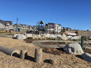 Community Amenities A vibrant community park with a playground and scenic views in Sunset Village: The Grand Collection by Lennar (Erie, CO).