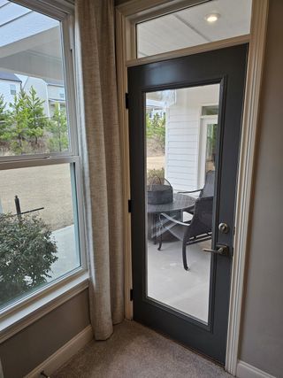 A charming patio door leading to a cozy outdoor seating area, perfect for relaxing mornings or quiet evenings.