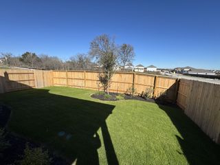 Street view A lush, fenced backyard space perfect for relaxation. Edgebrooke by Brohn Homes in Pflugerville, TX offers serene outdoor living.