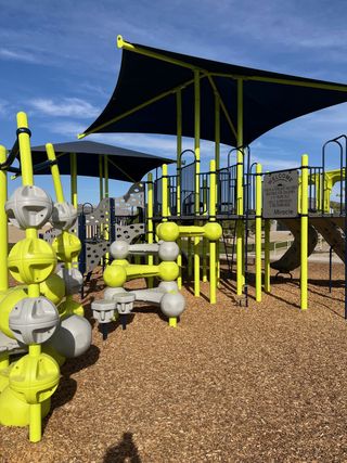 A vibrant playground with modern designs offers family fun in The Vistas Collection at Village at Sundance by Century Communities (Buckeye, AZ).
