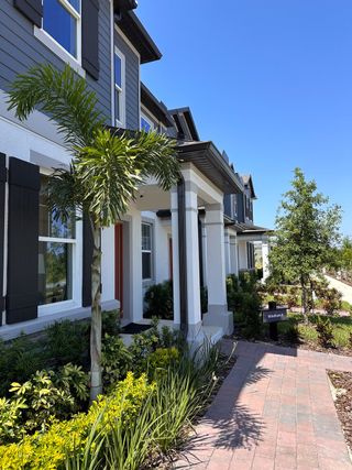 A modern home with lush landscaping and elegant design in Encore at Ovation by M/I Homes (Winter Garden, FL).