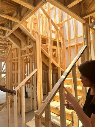 Wooden framework and stairs in a bright construction area, showcasing the early stages of home building.