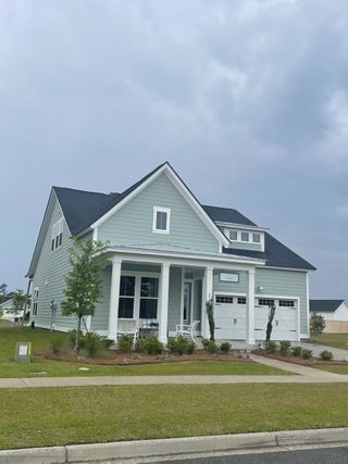 A charming pastel home with a spacious porch in Carnes Crossroads: Coastal Collection by Lennar (Summerville, SC).