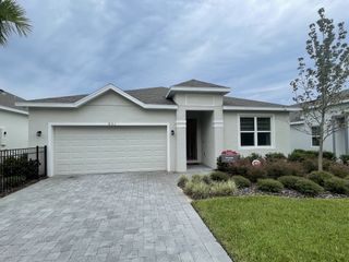 A modern home with a sleek driveway and manicured lawn in Mirror Lake Village by Park Square Residential (Fruitland Park, FL).