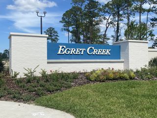 Elegant entrance sign amidst lush landscaping at Egret Creek by Mattamy Homes in Jacksonville, FL.