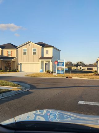 A charming light-colored home with modern siding in Saddle Oaks by Breeze Homes, Jacksonville, FL.
