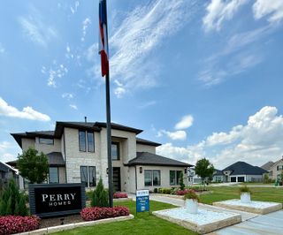 A beautiful two-story home with manicured gardens in Stonecreek Estates 60' by Perry Homes (Richmond, TX).