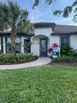 A charming modern home with lush landscaping in Oak Tree by Pulte Homes (Oakland Park, FL).