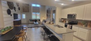 Model Home Open-concept living area with modern kitchen, cozy lounge, and stylish decor. Perfect for gathering and relaxation.