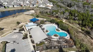 Community Amenities Aerial view of amenities, including a pool and clubhouse, in the Oaks at San Gabriel by Brohn Homes (Georgetown, TX).