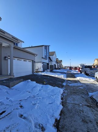 Snow-dusted modern homes line a quiet street in Legato by Century Communities, Commerce City, CO.