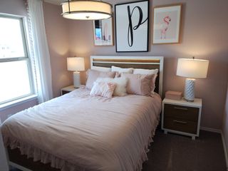 Model Home Soft and elegant bedroom with a blush color scheme, cozy bedding, and chic lighting for a warm and inviting retreat.