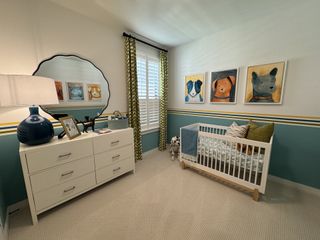Playful nursery room with dog-themed artwork, a white crib, and cheerful colors.