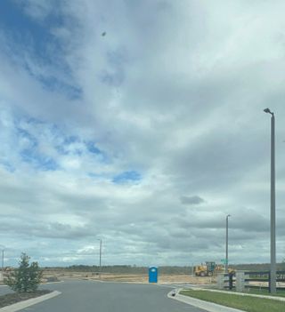 Street view A developing community with open skies in Springs at Lake Alfred - Signature Series by Meritage Homes (Lake Alfred, FL).