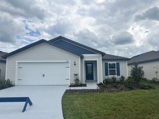 A charming single-story home with a manicured lawn in Westport Landing by LGI Homes (Jacksonville, FL).
