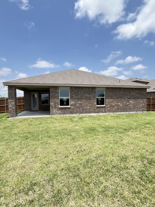 A charming brick home with a spacious backyard in Liberty Crossing by D.R. Horton (Royse City, TX).