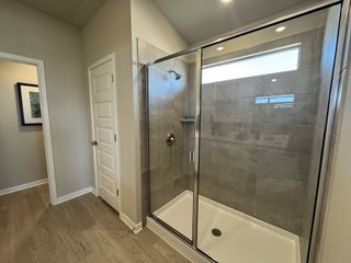 Model Home A modern bathroom featuring a spacious glass-enclosed shower and elegant tile work.