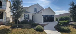 Street view Charming white brick home with manicured yard in Weston Oaks by View Homes (San Antonio, TX).