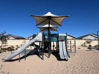 Community Amenities A modern playground with slides and shade in Northern Farms by Landsea Homes, Waddell, AZ.