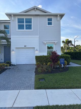 A stylish gray home with a manicured landscape in Veranda Landing by Lennar (Port St. Lucie, FL).