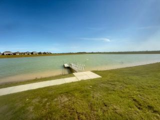 A peaceful lake with a private dock in Samara by Lennar (League City, TX), providing serene waterfront views and outdoor enjoyment.