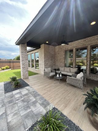 A stylish patio with cozy seating, modern tiles, and greenery. Perfect for outdoor relaxation and entertaining guests.