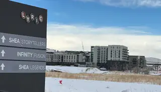 Street view Modern apartment complex in Lyric at Ridgegate by Infinity Properties, with snowy surroundings in Lone Tree, CO.