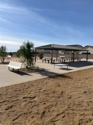 Community Amenities A modern community space with covered seating and desert landscaping in Wildera – Canyon Series by Landsea Homes (San Tan Valley, AZ).