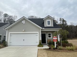 A charming gray home with a spacious garage and manicured yard in Horizons at Summers Corner by Lennar (Summerville, SC).