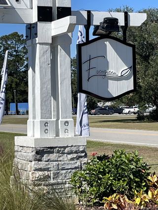 Elegant entrance signage with stone and wood in Evergreen by D.R. Horton, Holly Hill, SC.
