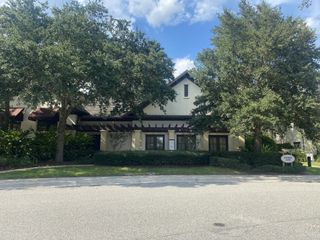 A charming facade with lush greenery in Reflections at Nocatee by Providence Homes (Nocatee, FL).