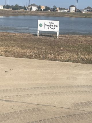Future gazebo, pier, and dock area by a serene lake at Tealpointe Lake Estates by Jamestown Estate Homes (Tomball, TX).