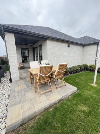 A cozy patio with wooden furniture and stone tiles, perfect for outdoor dining.