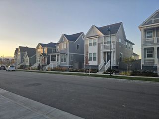 A row of charming modern homes at sunset in the Westerly community by Brightland Homes in Erie, CO.