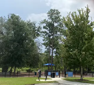 A serene park setting with lush trees in Granville at eTown 38' by David Weekley Homes (Jacksonville, FL).