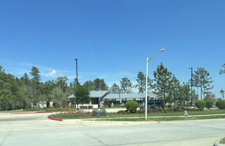 A scenic community view with lush greenery in Mavera by Meritage Homes (Conroe, TX).