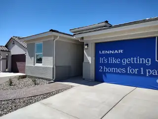 A modern home with a tile roof and landscaped yard in Asante Artisan: Signature by Lennar (Surprise, AZ).