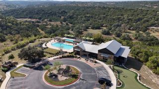 Stunning amenities at Sweetwater by Perry Homes, featuring two pools, shaded lounging areas, and a modern clubhouse (Austin, TX).