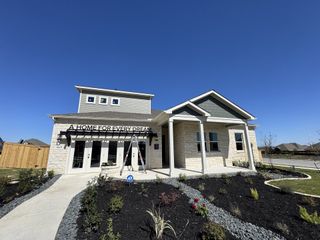 A modern home with elegant stone accents and landscaped garden in Homestead by Century Communities (Schertz, TX).